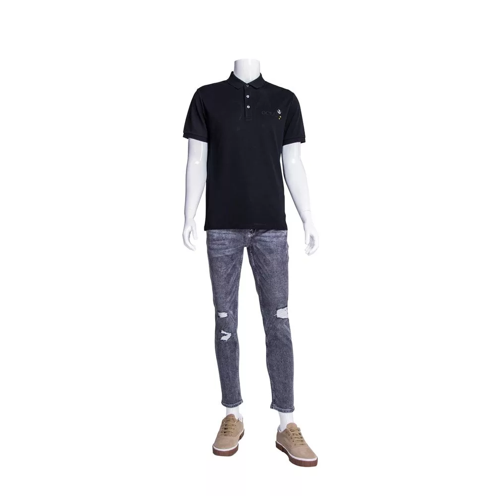 A Percy Plastic Gloss White Male Mannequin is outfitted in a black polo shirt and distressed gray jeans, complemented by brown sneakers. The mannequin exudes confidence as it stands against a plain white background.