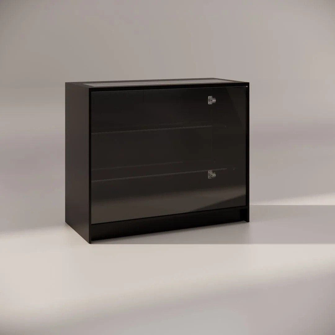 A black, glossy, rectangular display cabinet with transparent glass doors and two metal door handles, viewed against a neutral background. The cabinet has two shelves inside and a minimalistic design.