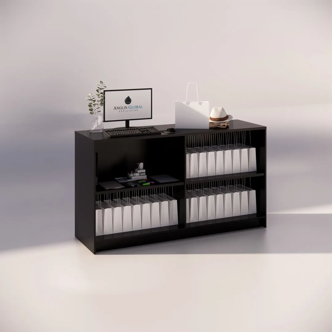 A sophisticated 1800mm Black Timber Counter functions as a reception desk, showcasing two shelves stocked with white folders, a small plant, a monitor displaying the logo, a keyboard, a white shopping bag, and a straw hat on top. The minimalist arrangement is elegantly well-organized.
