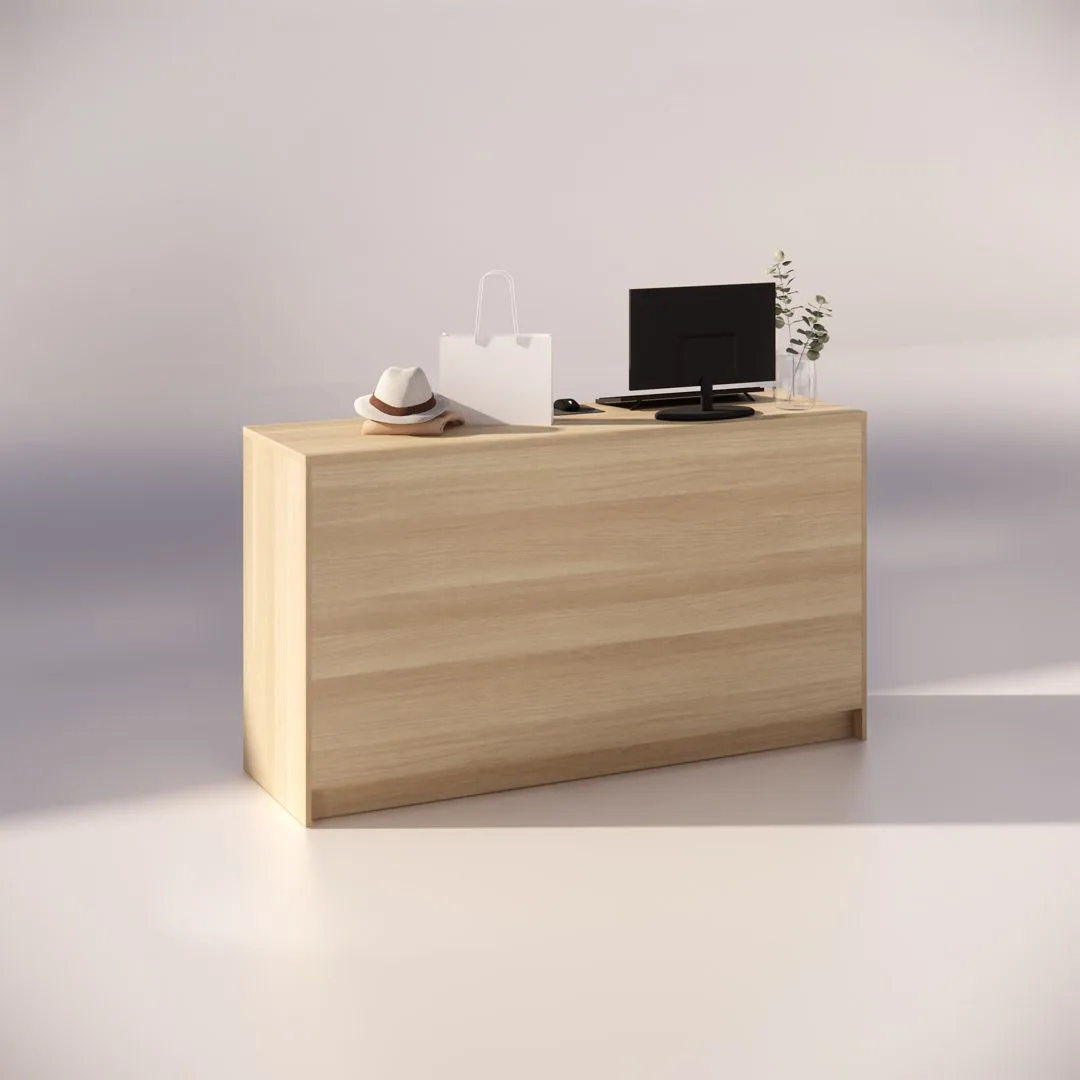 A minimalist wooden desk with a computer monitor, a small plant, a white shopping bag, and a hat placed on it, set against a soft, blurred background.