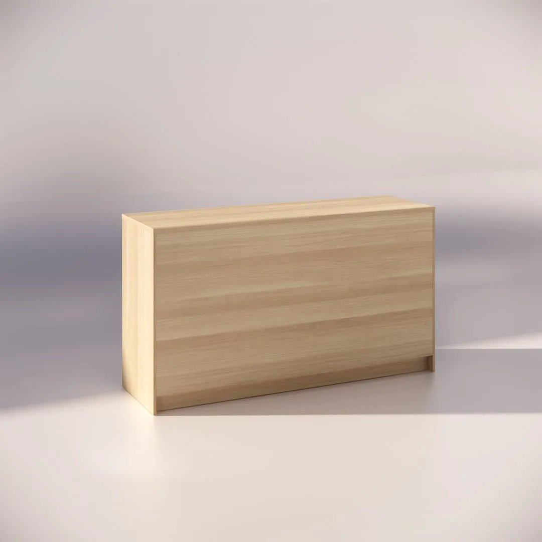 A minimalist wooden rectangular block with a smooth surface is placed on a light background, casting a soft shadow to the left. The block has a light wood grain texture and appears to be a piece of furniture or decor.