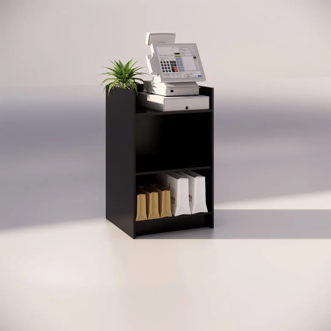 The Black Timber Register Counter is elegantly displayed with a cash register, a small potted plant, and a white box on its surface. Beneath the counter, shelves are neatly organized with brown and white shopping bags. The area is well-lit, contributing to a clean, minimalist backdrop.
