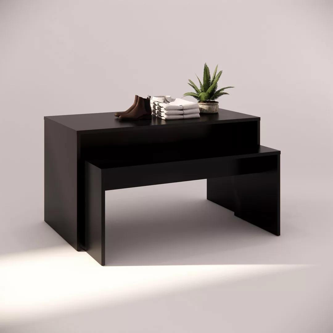 A modern black display table with stacked clothes, a pair of brown shoes, and a small potted plant. The scene is well-lit and minimalist, emphasizing the sleek design of the furniture against a neutral background.